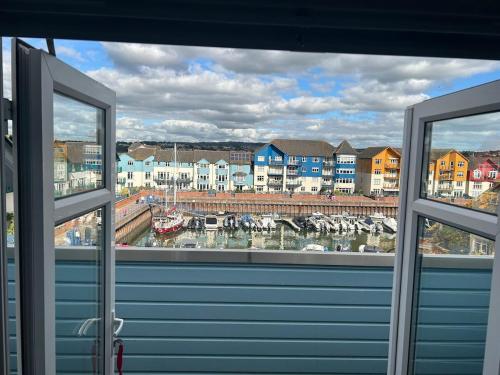 a view from a window of a harbor with boats at Madison Wharf - Waterside - Balcony in Exmouth