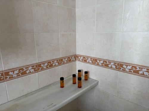 a bathroom with a bath tub with bottles on it at Villa con Piscina climatizada in Sanlúcar de Barrameda