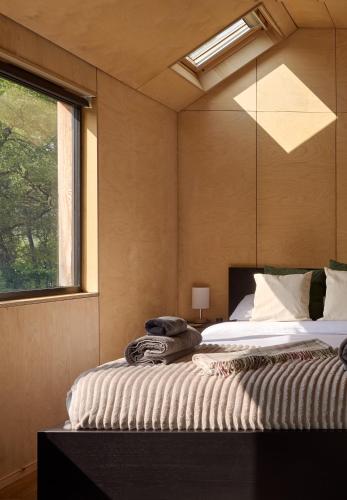 a bedroom with a large bed with a window at The Dell at Glenlivet in Glenlivet