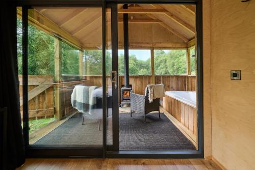 a screened in porch with a table and a tub at The Dell at Glenlivet in Glenlivet