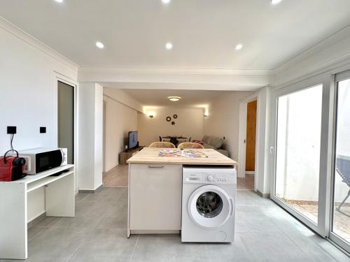 a kitchen with a washing machine in a room at Albufeira Amazing View With Pool by Homing in Albufeira