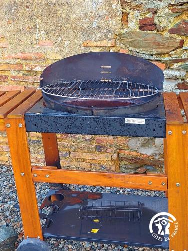 a grill with a pan on top of a table at GITE LE PLESSIS in Gennes-sur-Glaize