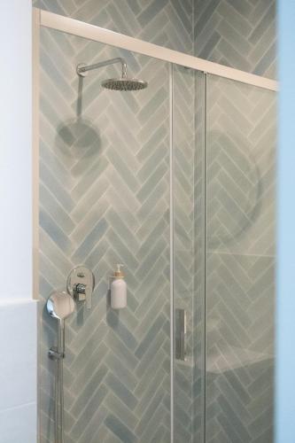 a bathroom with a shower with a glass door at Delphis Pula Rooms in Pula