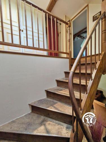 a staircase in a house with wooden railings at La Hérissière in Bazouges