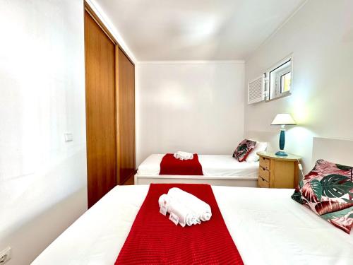 a bedroom with two beds and a red blanket at Monte Gordo Vila Verde by Homing in Castro Marim