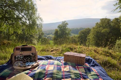 a bed with a military truck on top of a blanket at The Dell at Glenlivet in Glenlivet