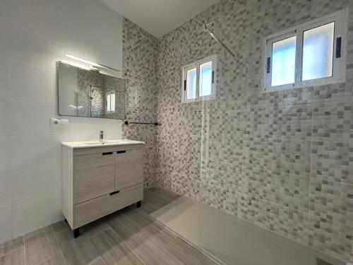 a bathroom with a sink and a shower at Villa with Pool, Chill-Out & BBQ in Torrevieja