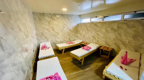 a room with two beds and two tables in it at Aselefech Merga Hotel and Spa in Addis Ababa