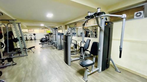 a gym with several treadmills and tread machines at Aselefech Merga Hotel and Spa in Addis Ababa