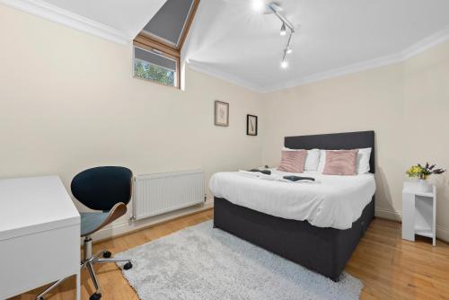 a bedroom with a bed and a desk and a chair at Leamington Spa Warwick Place Apartments in Leamington Spa