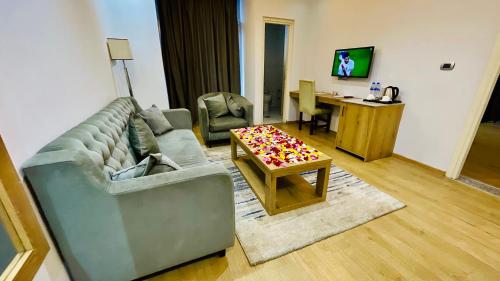 a living room with a couch and a table at Aselefech Merga Hotel and Spa in Addis Ababa