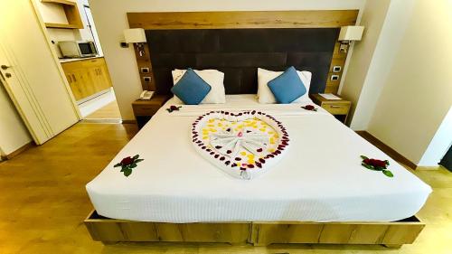 a bedroom with a large bed with a heart on it at Aselefech Merga Hotel and Spa in Addis Ababa