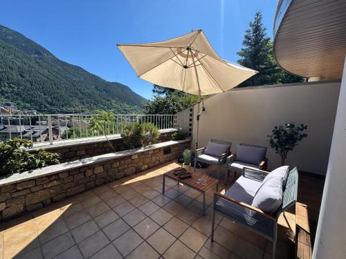 a patio with a table and an umbrella at Casa Marsal - Proap Apartments in Encamp