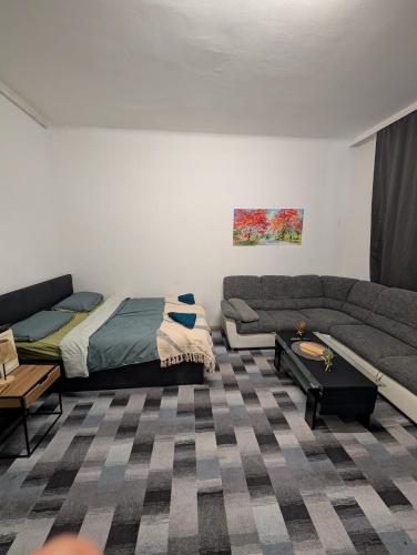a living room with a couch and a bed at Cozy Apartment in Simmering in Vienna