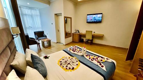 a hotel room with a bed and a living room at Aselefech Merga Hotel and Spa in Addis Ababa