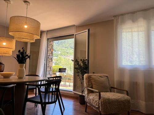 a dining room with a table and chairs and a window at Casa Marsal - Proap Apartments in Encamp