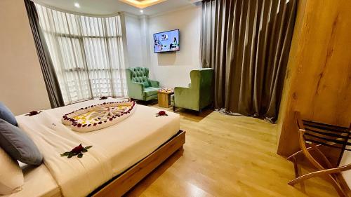 a bedroom with a bed with a cake on it at Aselefech Merga Hotel and Spa in Addis Ababa