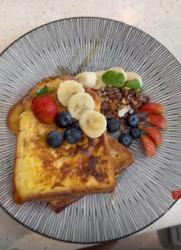 a plate with toast with fruit and vegetables on it at Villa Sugi Umalas in Canggu