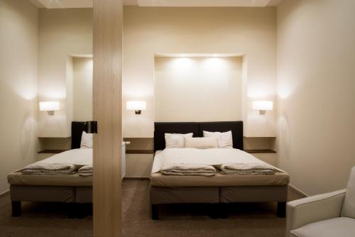 ブダペストにあるChairman's Apartmentのベッドルーム1室(ベッド2台、壁に照明2つ付)