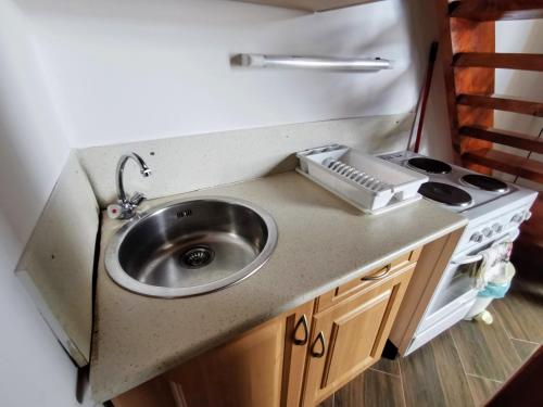 a kitchen counter with a sink and a stove at Napospart 32 in Balatonlelle