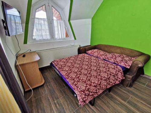 a small bedroom with a bed and a window at Napospart 32 in Balatonlelle