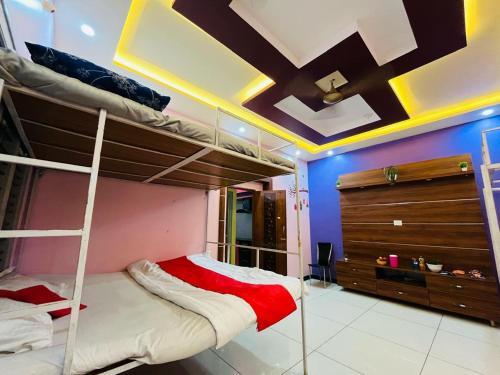 a bedroom with two bunk beds and a dresser at ADH Amilia Nest in Mysore