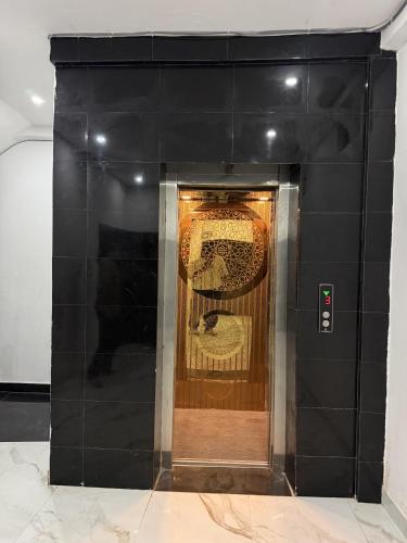 a black wall with a door in a room at Hotel Ayodhya International in Ayodhya