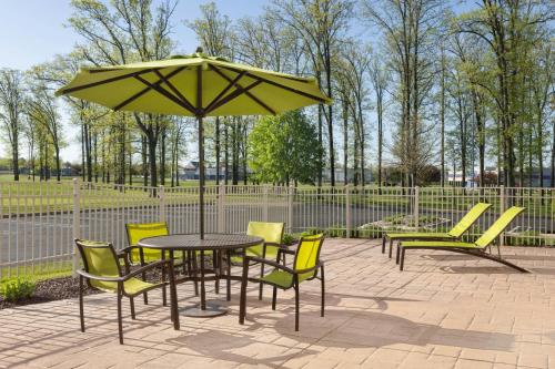 a table and chairs and an umbrella on a patio at SpringHill Suites Midland in Midland