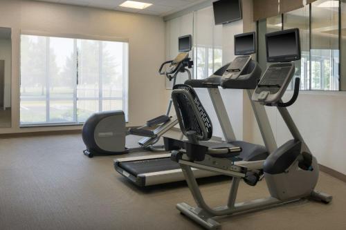 a gym with two tread machines in a room at SpringHill Suites Midland in Midland