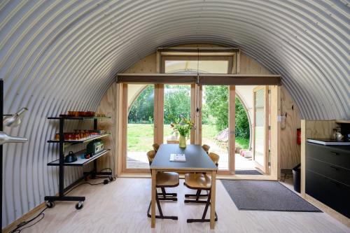 een kamer met een tafel in het midden van een huis bij Het Lage Noorden in Marrum