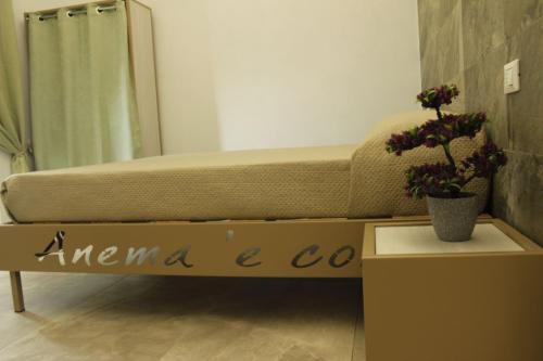 a room with a bed and a table with flowers at B&B Anema'e Core in Gaeta