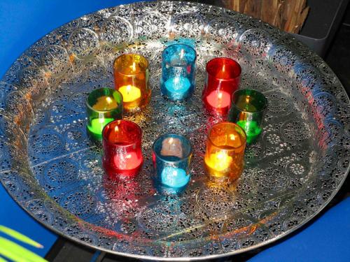 a group of colorful candles sitting on a glass plate at Le Relais des Fagnes in Sart-lez-Spa