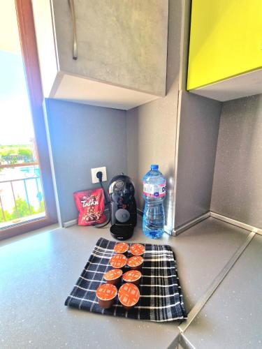 a kitchen counter with cupcakes and a bottle of water at LOVE 2 apartment in Aheloy