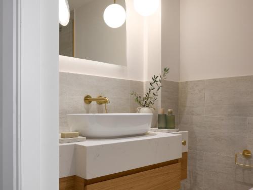 a bathroom with a sink and a mirror at Grecotel Filoxenia in Kalamata