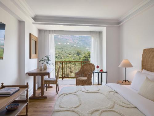 a bedroom with a bed and a balcony with a view at Grecotel Filoxenia in Kalamata