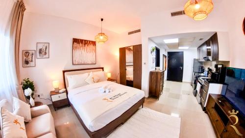 a bedroom with a bed and a living room at Cozy Urban Studio - Peach Bliss Haven in Abu Dhabi