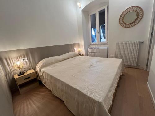 a bedroom with a bed and a mirror on the wall at Camogli - Il Caruggio di Mirella - Liguria Holidays in Camogli