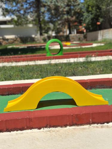 a yellow plastic slide in a park at Sentido Kyknos Beach Adults Only in Malia