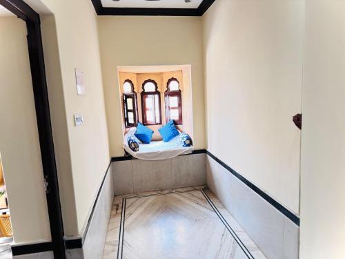 a room with a bed and a mirror on the wall at Ideal Guest House in Jaisalmer