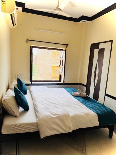 a bedroom with a large bed with a window at Ideal Guest House in Jaisalmer