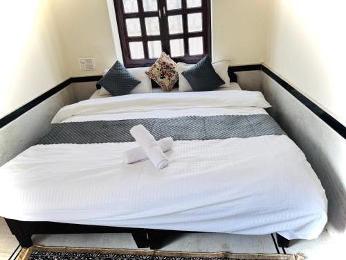 two beds with a cross on top of them at Ideal Guest House in Jaisalmer