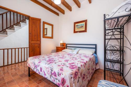a bedroom with a bed and a staircase at Ca'n Jaume i na Mama Antonia in Sóller