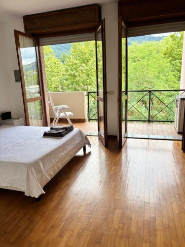 a bedroom with a bed and a balcony at Helena home in Torre De' Roveri