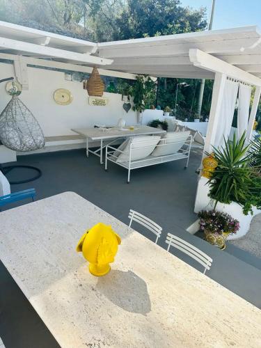 a yellow duck sitting on a table in a patio at Casa Molo 13 in Mattinata