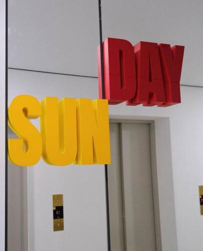 a sign for the sun on top of a building at Sunday Hotel in Odesa