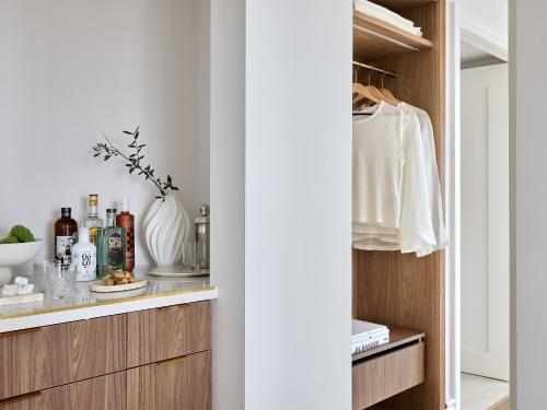 a kitchen with a counter with bottles and a shelf at Grecotel Filoxenia in Kalamata