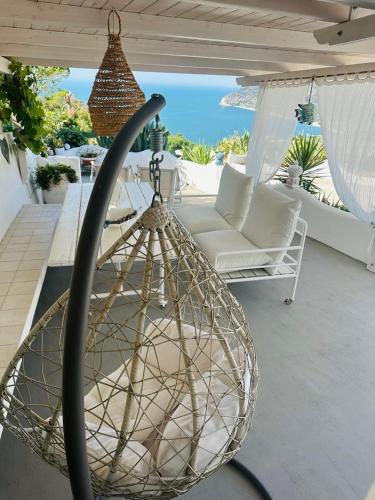 a net basket hanging from a table on a patio at Casa Molo 13 in Mattinata