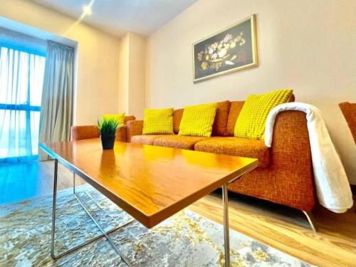 a living room with a couch and a table at YamaLuxe Luxury Apartments - București in Bucharest