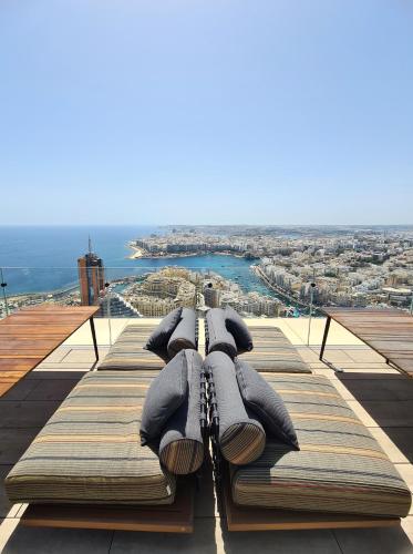 a pile of pillows sitting on top of a building at Sky High Luxury Apartment in Mercury Towers with Infinite Seaviews in St. Julianʼs