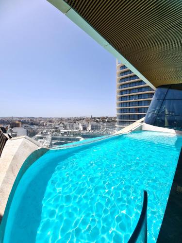 a swimming pool on top of a building at Sky High Luxury Apartment in Mercury Towers with Infinite Seaviews in St. Julianʼs